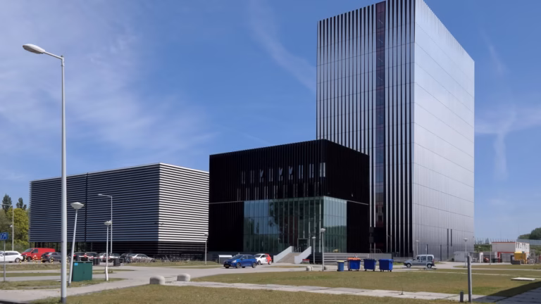 The Equinix AM3 and AM4 colocation data centre buildings in Amsterdam, a low-rise block beside a taller tower