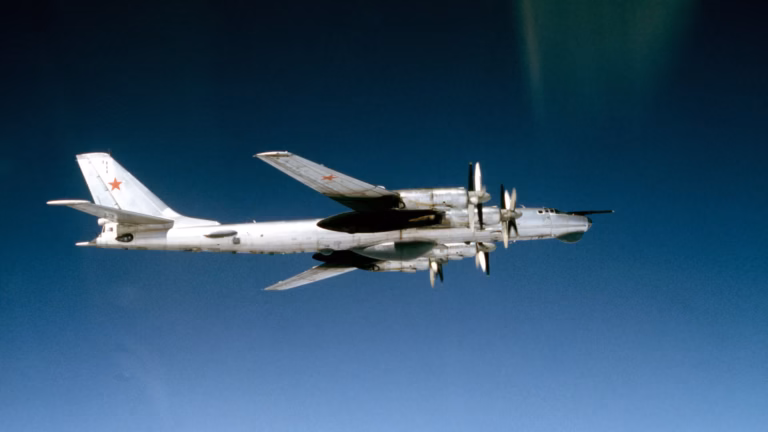 A Soviet Tu-95 Bear bomber in flight, the aircraft type modified to drop the Tsar Bomba