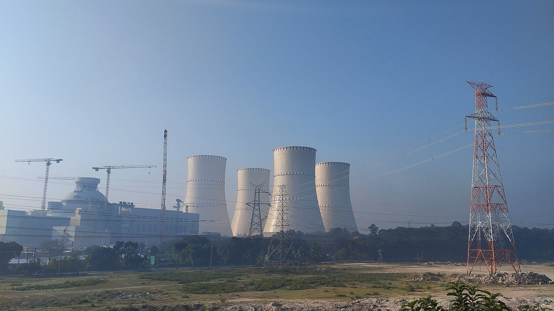 A nuclear power plant cooling tower, the generation data centres are contracting directly rather than queueing for grid capacity