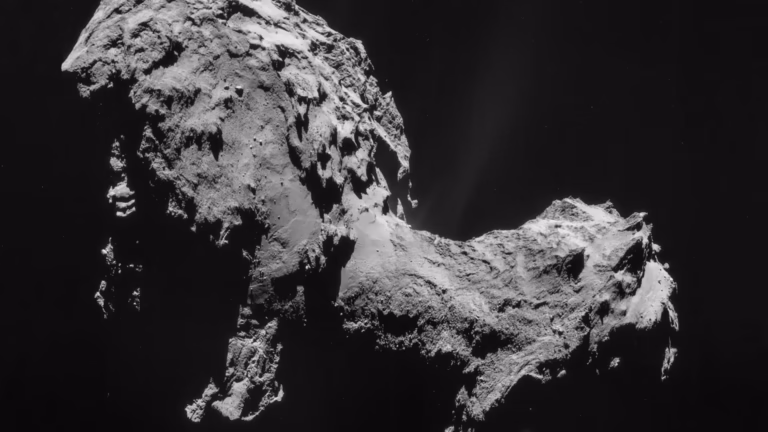 Comet 67P/Churyumov-Gerasimenko photographed by ESA's Rosetta spacecraft from 28.6 km, with faint jets of gas and dust rising from its neck