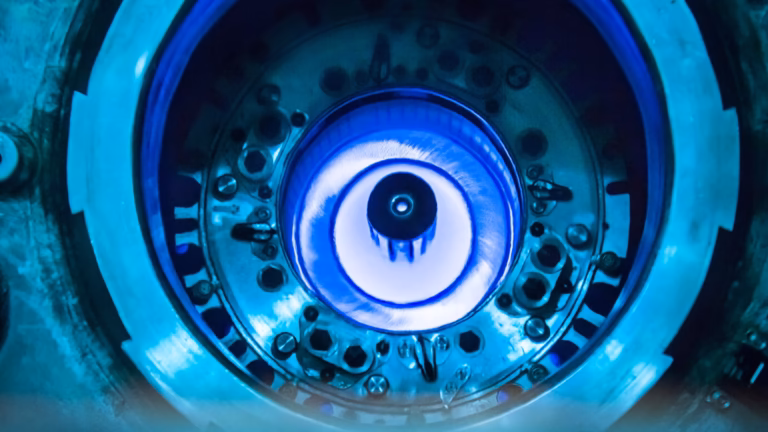 Blue Cherenkov glow in the water above the core of the High Flux Isotope Reactor, a research reactor at Oak Ridge National Laboratory, during refuelling in July 2015