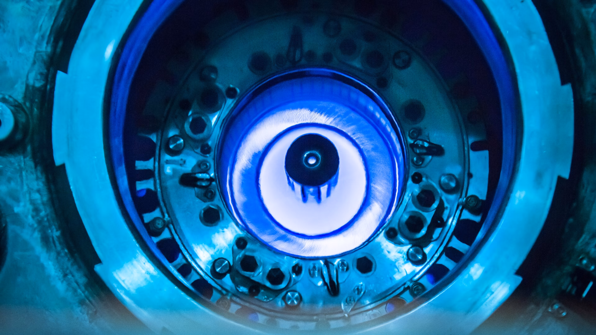 Blue Cherenkov glow in the water above the core of the High Flux Isotope Reactor, a research reactor at Oak Ridge National Laboratory, during refuelling in July 2015