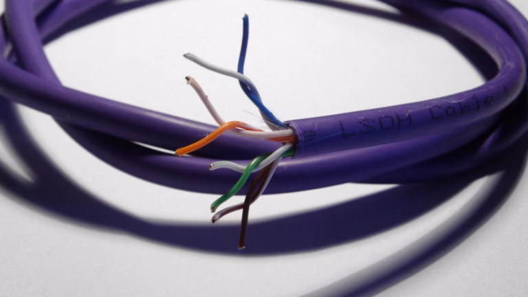 A coiled purple Ethernet cable with its jacket cut back to expose the twisted pairs of copper wires