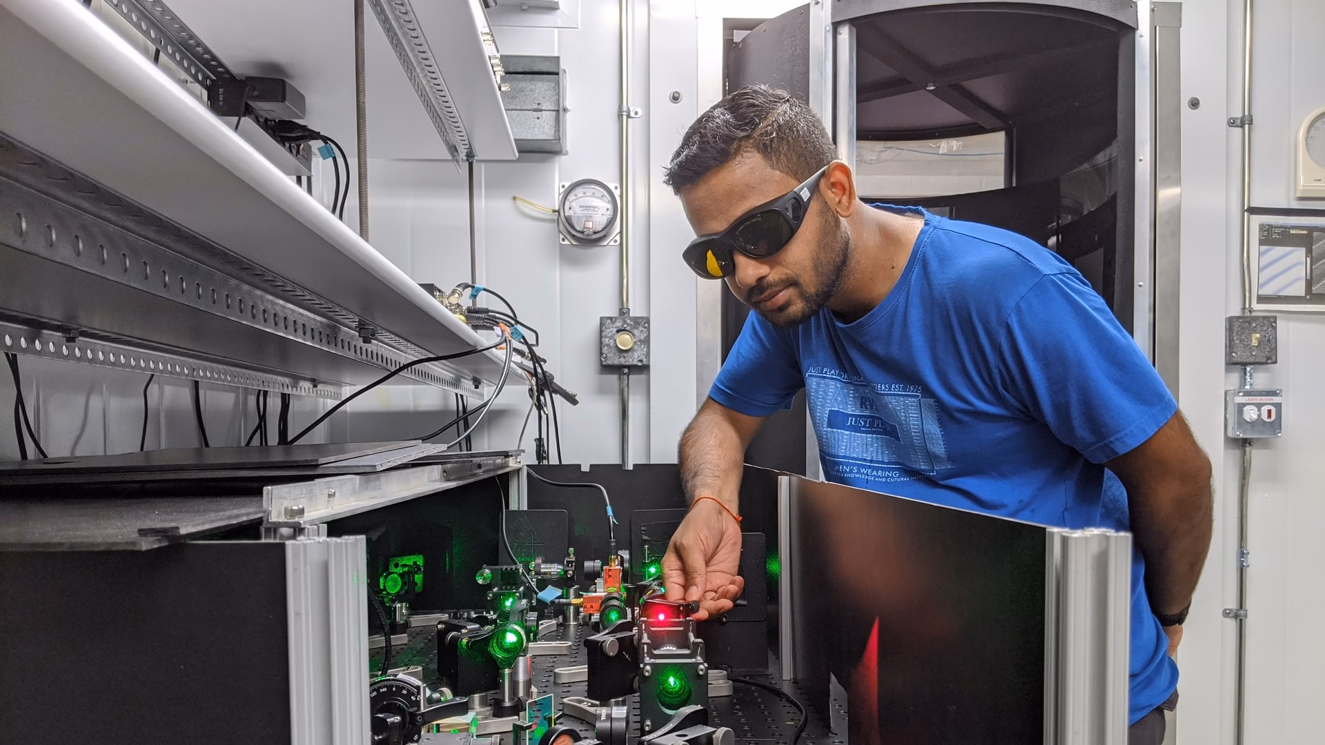Physicist Avinash Kumar adjusts the laser optics of the Simon Fraser University experiment that demonstrated a Mpemba effect with microscopic particles
