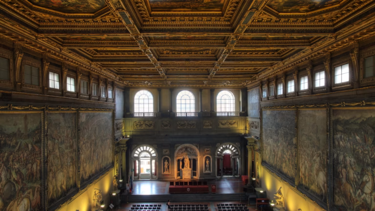 The Salone dei Cinquecento in Florence's Palazzo Vecchio, where Leonardo and Michelangelo were commissioned to paint rival battle murals; its walls now carry Vasari's frescoes