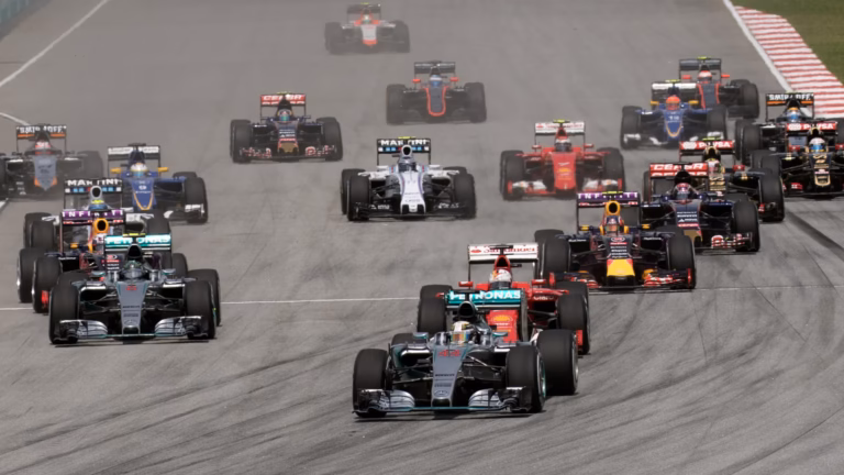 The field of Formula 1 cars on the opening lap of the 2015 Malaysian Grand Prix