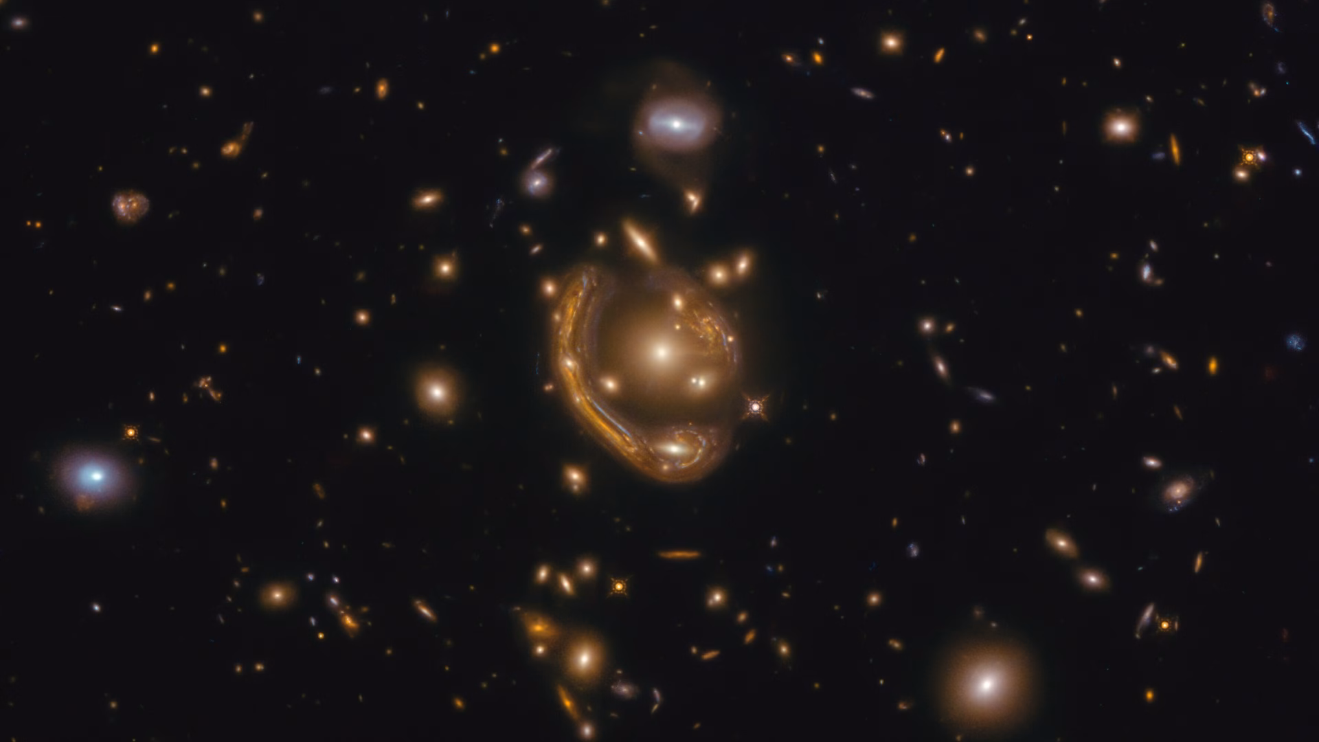 Immagine di Hubble di una galassia lontana la cui luce viene piegata in un anello quasi completo attorno a una galassia in primo piano: un anello di Einstein