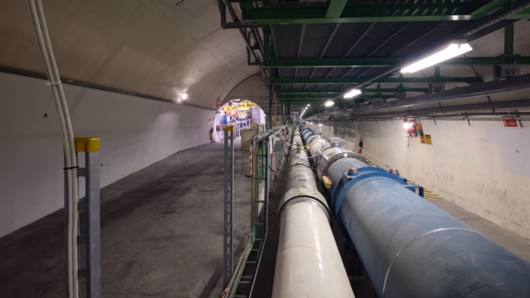 The Large Hadron Collider's magnets receding along its 27 km tunnel, with the side tunnel that houses the FASER experiment at left
