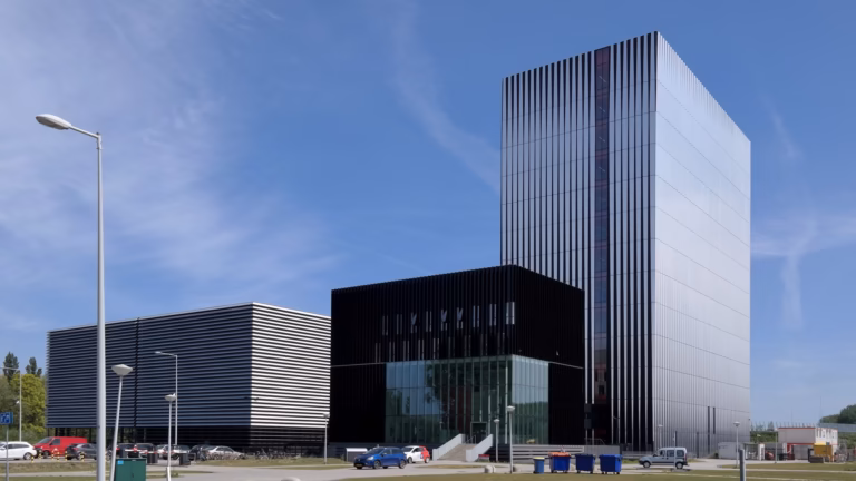 The Equinix AM3 and AM4 data centre buildings in Amsterdam, a low-rise hall beside a multi-storey data tower in the city